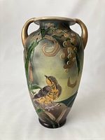 Front view showcasing hand-painted swallow bird and floral relief decoration on amphora vase with two handles.