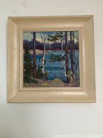 Straight-on view of framed painting on white wall