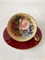 Tea cup and saucer set, top-down view showing floral interior and saucer