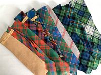 Nine men's wool ties displayed side-by-side showing various Scottish tartan patterns and colors.
