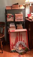 Four shelves of vintage Christmas decoration boxes and stand