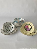 Photo showing all three Paragon teacups and saucers with different floral and courting couple designs