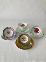 Overview of four Paragon bone china teacups and saucers arranged together
