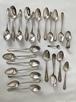 All spoons laid out on white background