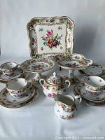 Full arrangement of all 13 porcelain pieces on white background