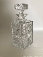 Front-side view of the lead crystal pinwheel whiskey decanter with stopper in place, showing detailed cut pattern