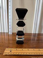 Side view showing the full candlestick with a ruler for scale, approximately 7.5 inches tall.