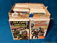 Wooden crate filled with vintage comic books from Marvel and DC, packed upright in plastic sleeves.