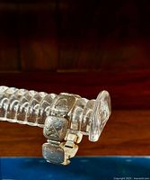 Photo showing a segment of the sterling silver bracelet on a display stand, highlighting the carved scrollwork details on the square links.