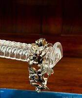 Chunky vintage sterling silver floral bracelet displayed on a clear ridged bracelet stand showing large, detailed flowers with a natural patina and oxidation.