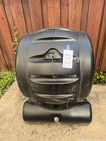 Front view of closed compost tumbler bin on base with lot tag