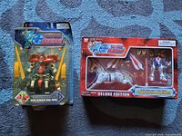 Front of Dark Gundam Final Mode blister pack and Deluxe Burning Gundam & Mobile Horse window box
