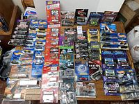 Overview shot of entire lot laid out on table showing over fifty sealed packages