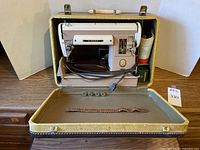 Singer 301A sewing machine inside case with accessories displayed on lid