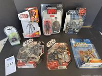 Front view of the figures in packaging, showcasing variety of characters including Godzilla and Star Wars figures such as Cad Bane and Aqua Droid.