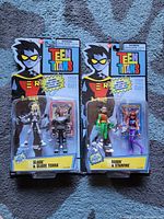 Front of two sealed Teen Titans blister packs on carpet