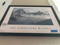 Framed print of The Cordillera Blanca mountain range featuring snowy peaks and cloud cover, with labels for San Juan (5843m) and Cayesh (5721m).