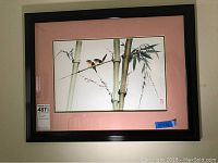 Full framed watercolor artwork with bamboo stalks and two colorful birds, with pink mat and black frame.