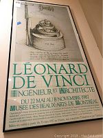 Full view of the framed Leonard de Vinci art deco print showing the mechanical drawing and exhibition details in French.
