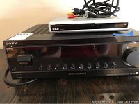 Photo of Sony Vision Touch G1ES stereo receiver with RCA DRC200N DVD player on top, showing front view with buttons and display