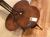 Top view of vintage clover-shaped wooden table showing surface and leg design.