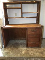 Front view of the vintage solid wood desk with attached bookcase and three drawers on the right side