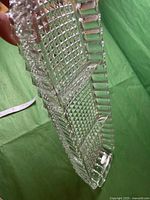 Angled side view of the crystal tray showing the textured pattern and dividers.