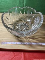 Crystal fruit vase viewed from front showing scalloped edges and detailed cut design.