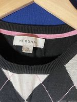 Close-up of the Merona brand label and size tag showing XS and 100% cotton material.