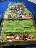 Full image of apron showing title 'Irish Recipes' and recipes including Irish Stew, Irish Coffee, Potato Pearls, Baked Salmon, Wheaten Bread, Hare Soup