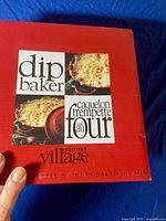 Front view of branded packaging box of Gourmet Village dip baker with leek & onion baked dip mix.
