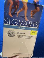Two photos of the product packaging for Sigvaris 230 Series medical cotton compression stockings, size M4.