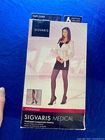 Front of box showing Sigvaris brand, model Eversheer graduated compression hosiery with an image of a woman wearing black pantyhose and a skirt.
