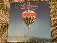 Front cover of the Air Supply LP record titled "The One That You Love" featuring a hot air balloon with heart shapes.