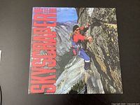 Front cover of David Lee Roth Skyscraper LP showing climber on cliff.