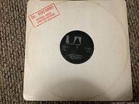 Front of plain white sleeve with black vinyl record label showing Dr. Feelgood and 'She's A Windup' track info