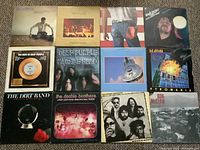 Photo of all 12 LP record covers showing a variety of artists and album art.