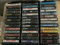 Overview photo showing 42 rock cassette tapes stacked and arranged clearly, featuring well-known classic rock artists and some pop icons.