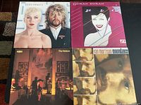 Photo showing four LP record covers laid flat: Eurythmics album with Annie Lennox and Dave Stewart, Duran Duran Rio album, Abba The Visitors album, and Van Morrison Moondance album.