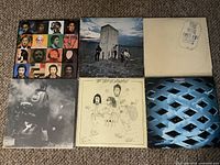 Photo of six The Who LP records arranged in two rows showing album cover art, colors and styles revealing the album variety and good condition