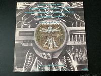 Rear view of album cover with 'Thunder Seven' track listing and detailed mechanical artwork.