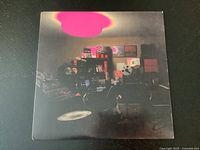 Front cover of the Multi-Love album by Unknown Mortal Orchestra showing a dimly lit room with a pink light.