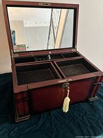 Front view of jewellery box open showing interior compartments and mirror