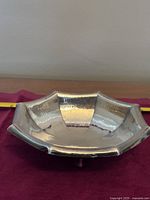 Front view of octagonal shallow bowl showing hammered interior and polished finish.