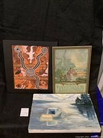 Three framed artworks including Aboriginal dot painting, oil landscape, and vintage print
