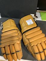 Top view photo of the vintage Cooper 64 hockey gloves showing wear and discoloration.