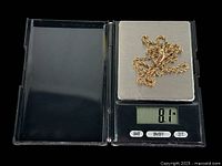 Chain placed on digital scale showing weight of 8.1g