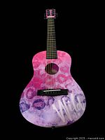 Front view of the colorful children's 6 string acoustic guitar with pink, purple, and blue body and Wild at Heart graphic.