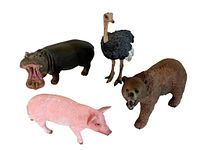 Four Schleich animal figures grouped together: hippopotamus, ostrich, bear, and pig.