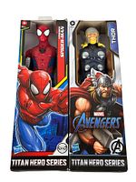 Front view of the boxed Titan Hero Series Spiderman and Thor action figures showing packaging and branding.